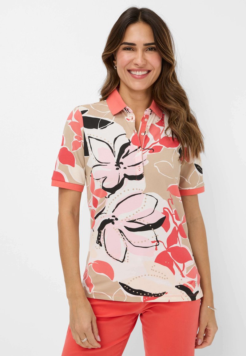 Kurzarm-Poloshirt in Beige mit floralen Mustern in Pink und Rot. Mit einem Korallenkragen und Knopfleiste. Glatte Stoffoberfläche.