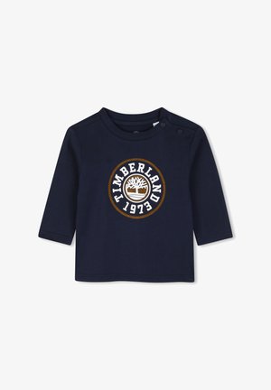 Marineblauw peutershirt met lange mouwen met Timberland-logo en 1973-tekst aan de voorkant en twee drukknoopjes op de schouder.