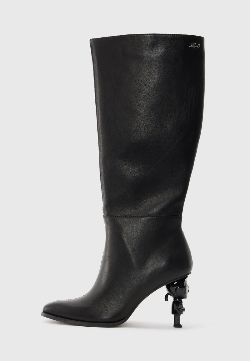 Black knee-high boot made of smooth leather. Features a pointed toe and a distinctive sculptural heel with a decorative accent.
