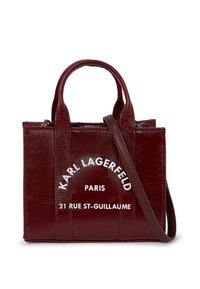 Burgundy leather handbag with dual top handles and a detachable shoulder strap. Features white text: "KARL LAGERFELD PARIS 21 RUE ST-GUILLAUME."