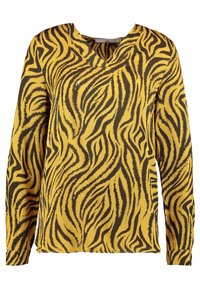 Blusa gialla a maniche lunghe con strisce ondulate nere simili a quelle di una zebra e un leggero colletto a V, esposta su uno sfondo bianco.
