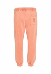 Pantalons de jogging en coton d'un doux pêche, avec une taille élastique, des poignets côtelés et une poche arrière avec un discret logo.