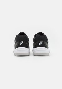 Black athletic sneakers with a textured upper, featuring grey accents, a white logo, and a cushioned white sole.