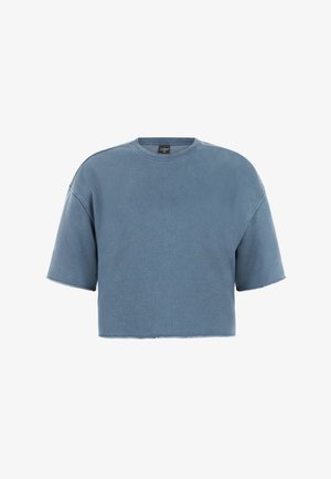 Sweat-shirt court à manches courtes dans une teinte bleue douce. Il présente un col rond et des bords bruts pour une coupe décontractée. Tissu au toucher doux.