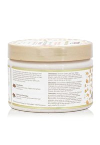 White circular jar with a beige lid, featuring printed design elements. Contains labels with directions, ingredients, and usage instructions.