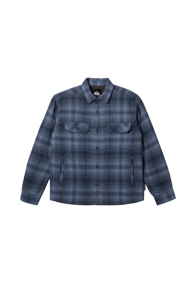 Chaqueta de cuadros en tonos azul oscuro y gris, con un cierre de botones en la parte delantera, dos bolsillos en el pecho y un cuello clásico. Textura de tela suave.