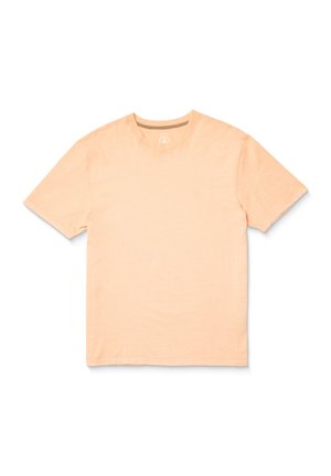 Helles Pfirsichfarbenes T-Shirt mit kurzen Ärmeln aus weichem Stoff. Mit rundem Halsausschnitt und dezenter Logo-Details auf der Brust. Glatte Textur.