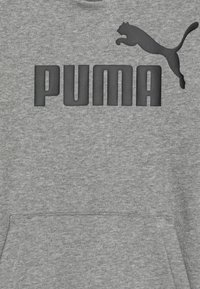 Sweatshirt gris avec un logo "PUMA" noir et un silhouette de puma en saut. Fabriqué en tissu doux avec une poche frontale et un col rond.