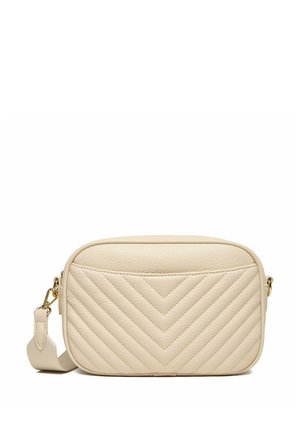Bolso bandolera beige acolchado con costuras en forma de chevron, bordes redondeados y correa desmontable con herrajes en tono dorado.