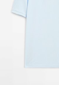 Light blue short-sleeved shirt made of soft fabric, featuring a simple round neckline and a smooth, textured finish.