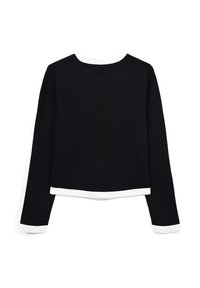 Haut noir à manches longues avec un col rond, présentant des accents blancs sur le col et les poignets. Texture lisse, design court.