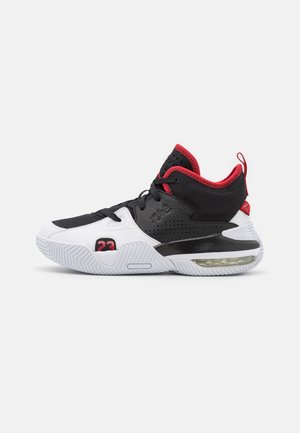 Black, white, and red basketball shoe with high ankle support, visible air cushion sole, black laces, and number "23" on outer side.