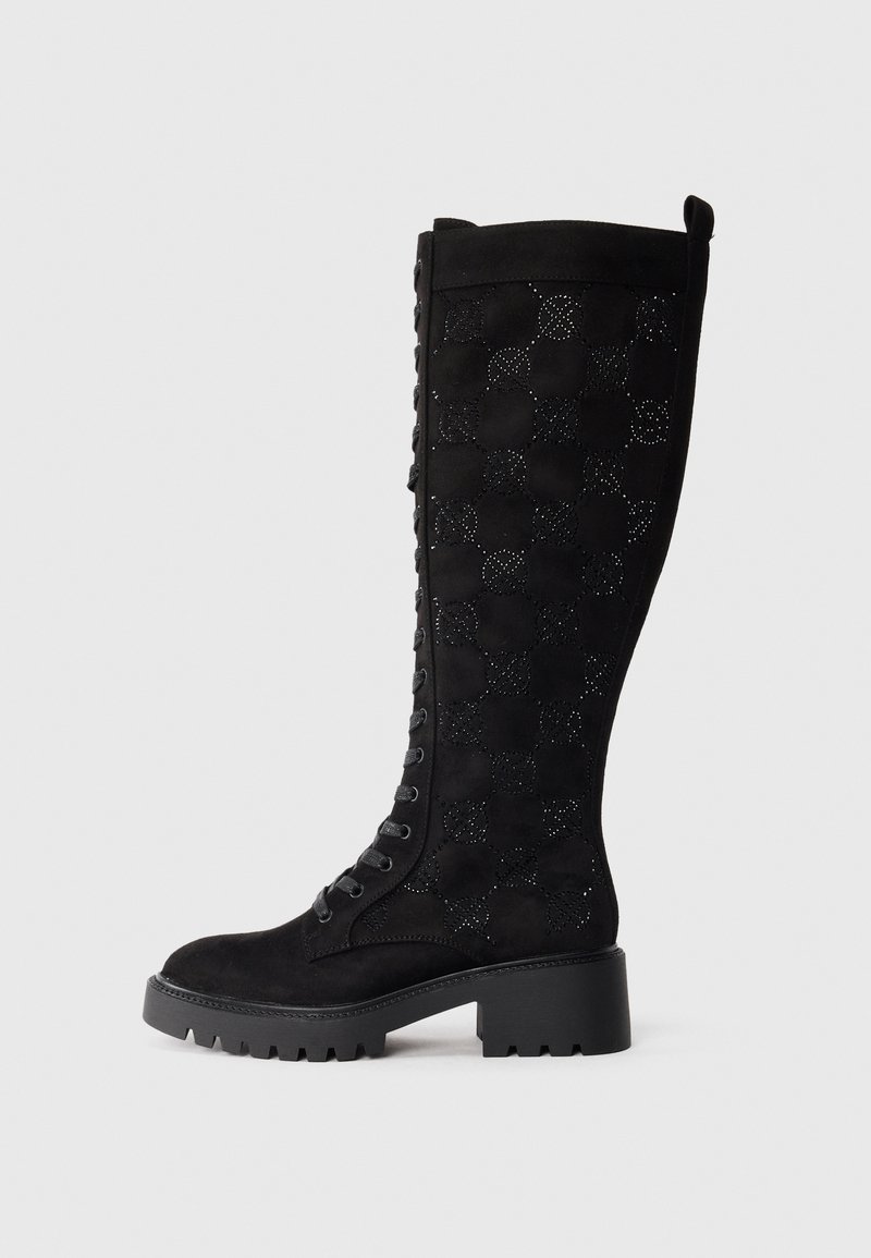 Black knee-high boots featuring a suede material with a checkered cut-out pattern, lace-up front, and a chunky, textured sole.