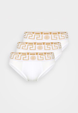 Three pairs of white briefs with a gold geometric pattern on the elastic waistband, featuring a central logo emblem. Soft cotton material.