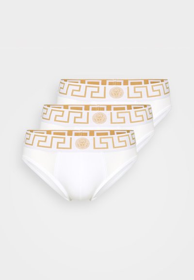 Trys balta apatinių kelnaičių poros su auksiniu geometriniu raštu ant elastingos juostos, kurių centre yra logotipo emblemą. Minkšta medvilnė.