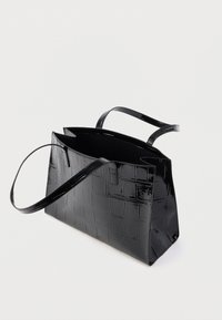 Black patent leather tote bag with a textured crocodile pattern. Features two long handles and an open top design.