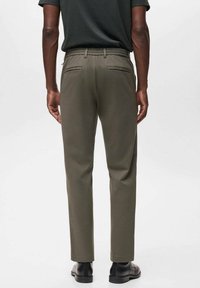 Olive green trousers with a straight fit, elastic waistband, and two back pockets. Made from a smooth fabric, styled with minimal detailing.
