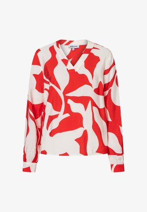 White long-sleeve blouse with bold red abstract leaf pattern and V-neck collar, displayed on a plain background.