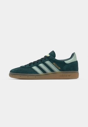 Green suede sneaker with three light green stripes, gum rubber sole, and gold "Spezial" text on the side. Low-top design with rounded toe.