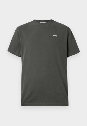 Dark green cotton t-shirt with short sleeves, round neck, and white “obey” logo on the left chest area. Standard fit.