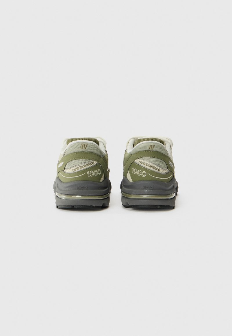 Zapatillas deportivas verdes y grises con parte superior de malla y sintético, que cuentan con una suela acolchada y un destacado logo "1000" en el talón.