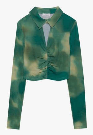 Green tie-dye top with long sleeves, a collared neckline, and gathered detailing at the center; textured fabric with ribbed pattern.