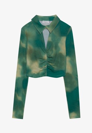 Green tie-dye top with long sleeves, a collared neckline, and gathered detailing at the center; textured fabric with ribbed pattern.