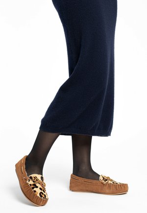 Bruine suède moccasinschoenen met een luipaardprint en franjes. Draagt ze met donkere panty’s en een lange marineblauwe jurk.