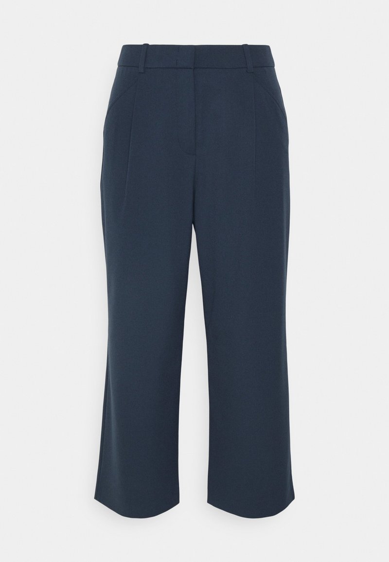 Pantalon bleu marine de coupe ajustée, présentant un devant plat, deux poches latérales et une coupe à jambes larges. Texture lisse sans motifs visibles.