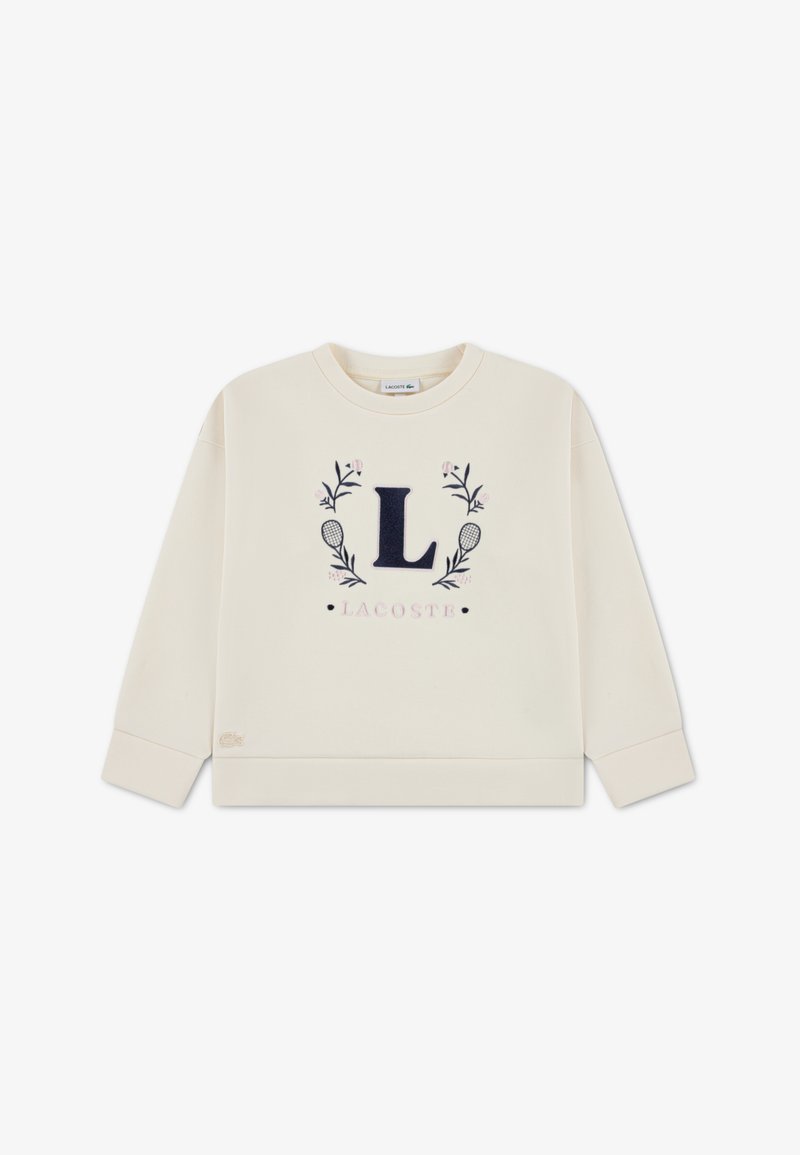 Φούτερ σε κρεμ απόχρωση με λογότυπο "L" σε ναυτικό μπλε και ανθισμένες λεπτομέρειες, με ριμπ μανσέτες και τελείωμα. Εκτίθεται επίπεδο σε λευκό φόντο.