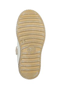 Beige Gummisohle mit einer strukturierten Oberfläche, die horizontale Rillen und verstreute Glitzerakzente aufweist. Rundes Logo-Abdruck sichtbar.