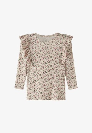 Haut pour enfant à manches longues avec motif floral rose et vert et détails volantés sur les épaules, fond crème, encolure ronde.