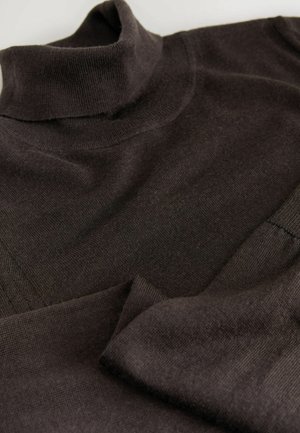 Brown turtleneck sweater with a soft, knitted texture. Features a high neck and overlapping panels in the body for a layered design.