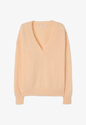 Vaalean persikanvärinen pitkähihaisen neuleen pusero, jossa on syvä V-kaula-aukko, resorit hihansuissa ja helmassa, valmistettu pehmeästä, pörröisestä neulospuvusta.