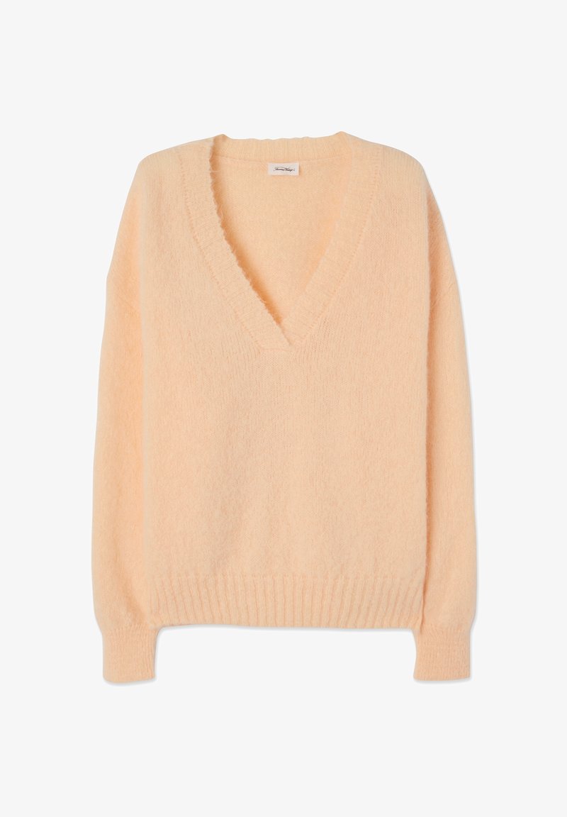 Pull long en maille pêche clair avec col en V profond, poignets et ourlet côtelés, fabriqué en tissu tricoté doux et duveteux.