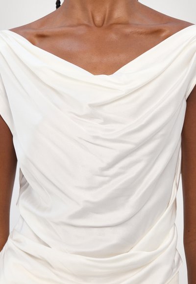 White draped top featuring a wide v-neckline, soft satin fabric, and subtle folds throughout the body for a fluid appearance.