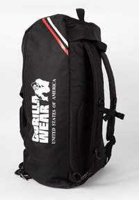 Black backpack with adjustable straps, featuring red and white stripes. Includes a logo and text "Gorilla Wear United States of America."