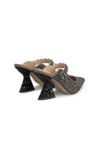 Mules à talons hauts gris à motifs avec un bout pointu, ornés de bijoux noirs sur le talon et les brides, présentant un talon triangulaire distinctif.