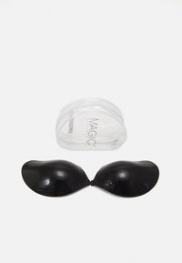 Black adhesive silicone cups shaped like half globes, connected at the center, placed next to a transparent storage case labeled "MAGIC."
