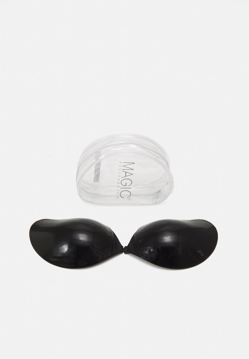 Black adhesive silicone cups shaped like half globes, connected at the center, placed next to a transparent storage case labeled "MAGIC."