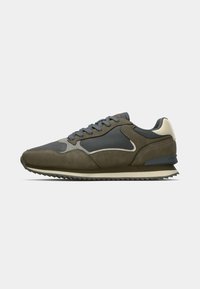 Olive green and grey athletic shoe with a combination of suede and mesh materials. Features a rubber sole and lace-up design.