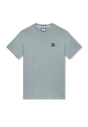 Gaiši zaļš kokvilnas T-krekls ar īsām piedurknēm. Uz kreisā krūšu daļas ir melns kvadrātveida logo. Apaļš izgriezums, vienkāršs dizains un gluda tekstūra.
