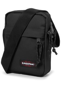 Borsa a tracolla Eastpak nera in tessuto testurizzato. Dotata di tracolla, chiusure con cerniera e patch con logo sul davanti. Design compatto.