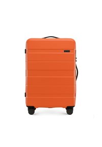 Orange hardshell suitcase with horizontal grooves, a retractable handle, and four black wheels for mobility. Brand logo on the front.