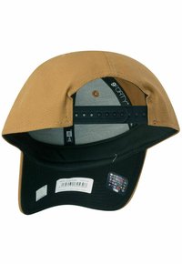 Brown fabric baseball cap with a black visor, sport-style, snapback closure, featuring a gray interior lining and a multi-logo sticker on the side.