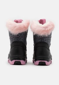 Bottes étanches noires avec une garniture en fausse fourrure rose, des détails en imprimé léopard et des semelles en caoutchouc dotées d'une semelle extérieure texturée rose.