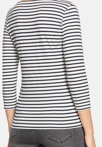 Langärmeliges Oberteil in Navy und Weiß mit Streifen, aus weichem Stoff, mit rundem Ausschnitt und leicht tailliertem Schnitt.