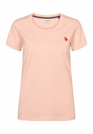 Svijetlo ružičasta pamučna majica s okruglim izrezom. Ima kratke rukave i mali crveni logo na lijevoj strani prsnog koša. Mekana tekstura, opušteni kroj.
