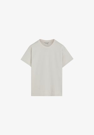 Camiseta de algodón color beige claro con cuello redondo, mangas cortas y un corte relajado. Textura suave, diseño minimalista, sin patrones ni detalles visibles.