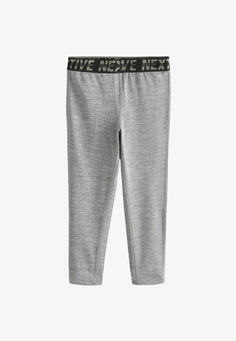 Leggings grises avec un motif texturé, doté d'une taille élastique noire avec la marque "NEX". Design ajusté, idéal pour les vêtements de sport.